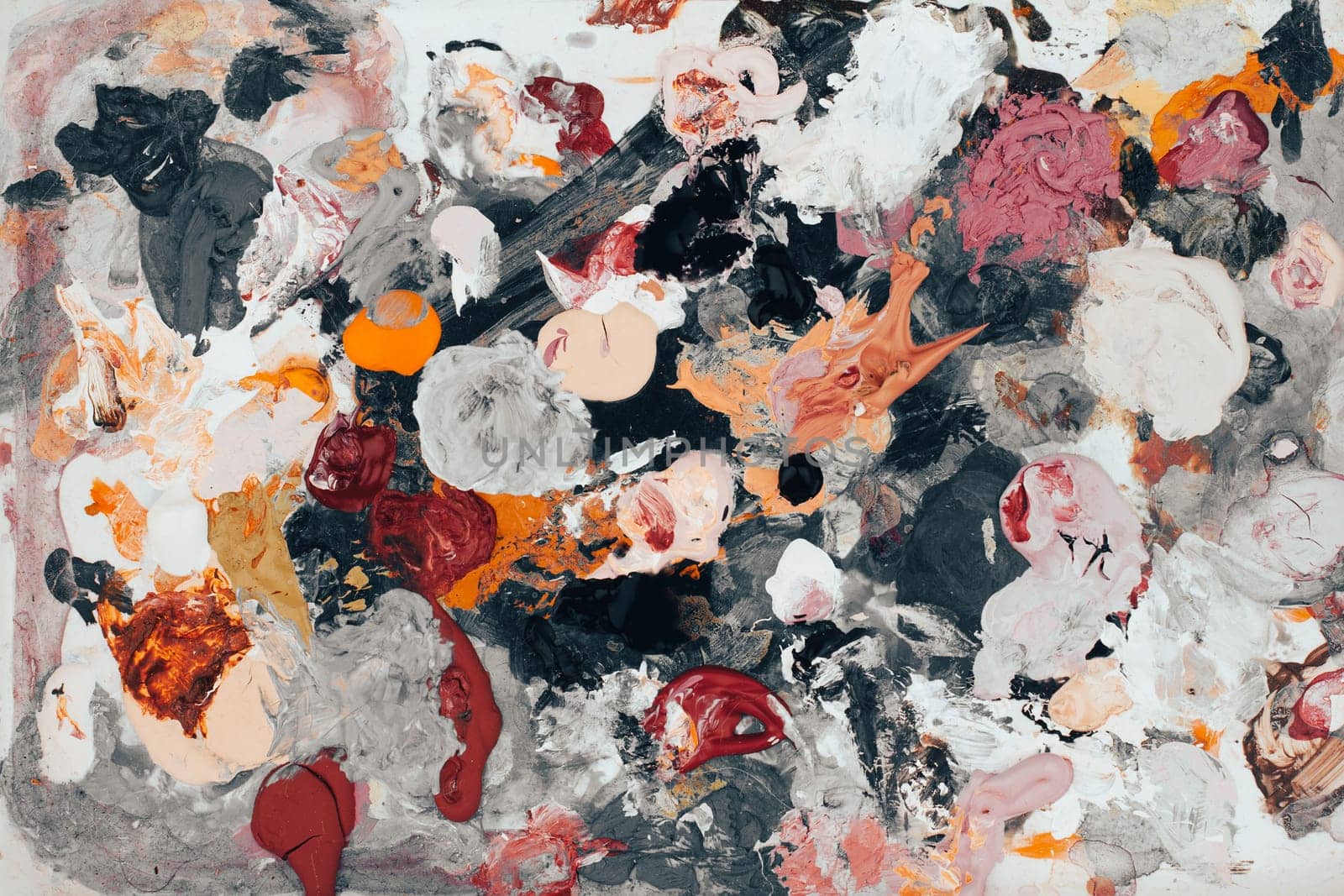 top view closeup of artist color mixing palette with colored brush strokes