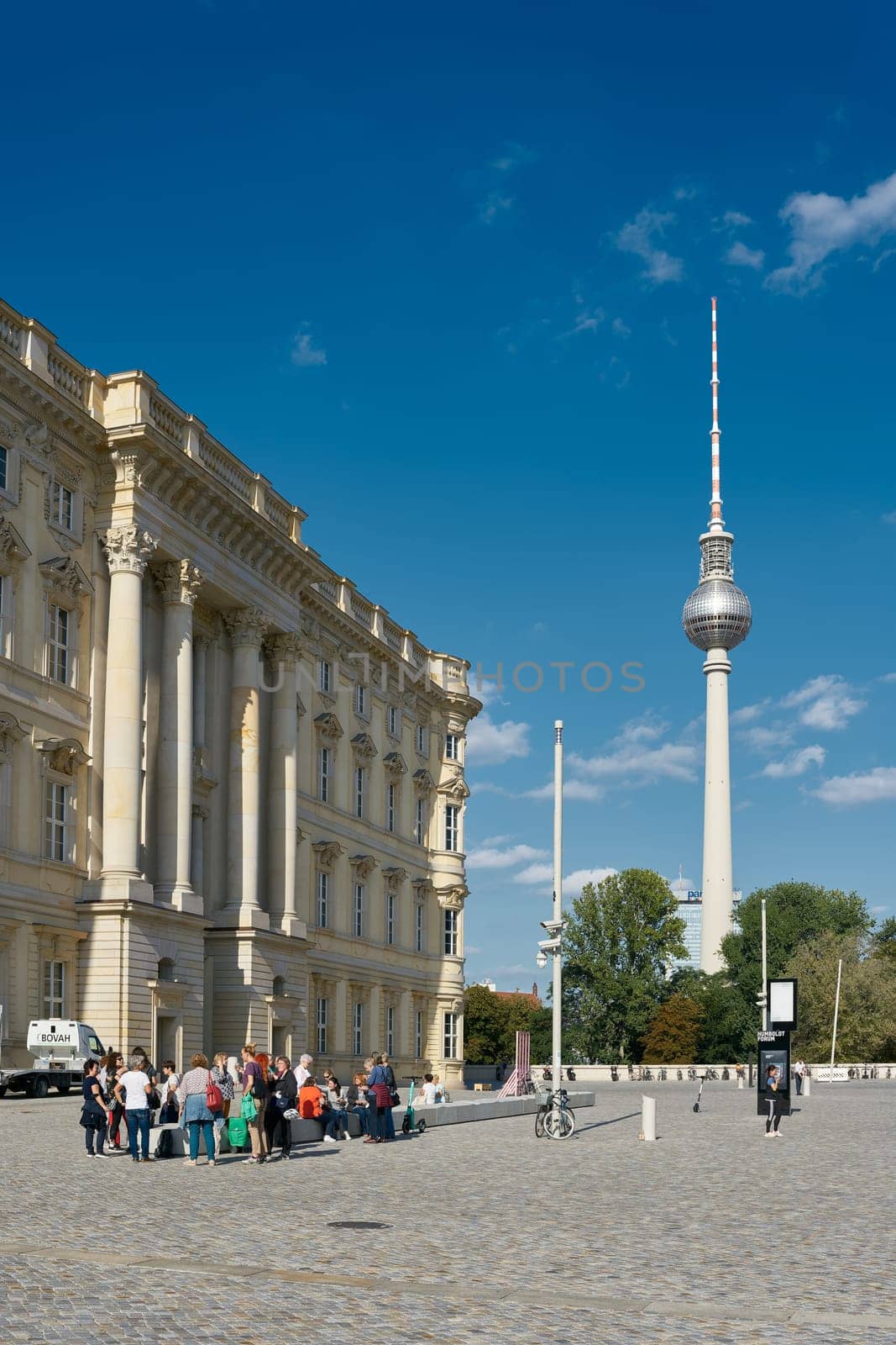 Tourist group in front of the Humboldt Forum in Berlin. In the background the Television Tower.