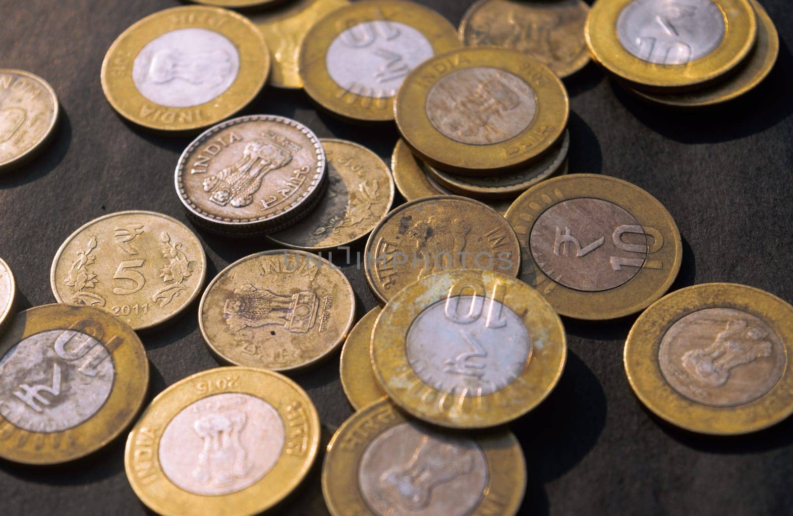 Heap of Gold Colored Indian Rupee Coin currency on rustic floor. Full Frame. High Angle View. Business Finance and financial Investment Background. Close Up