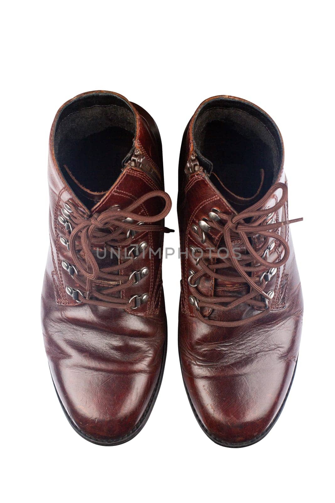 top view closeup of polished vintage brown leather boots isolated on white background