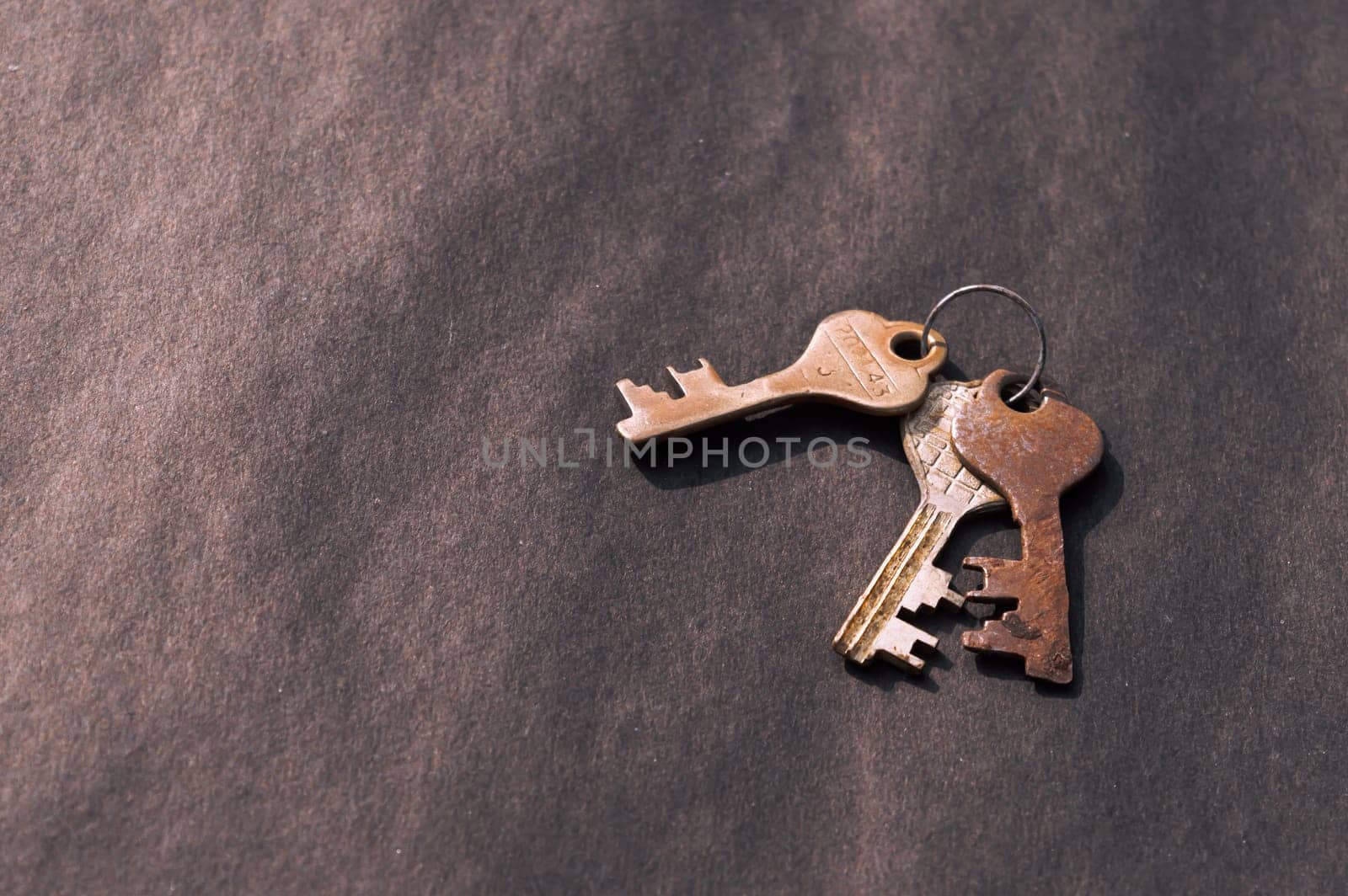 Bunch of old House Key isolated on a rustic Floor. High Angle View. Copy space room for text. Safety secure protection background concept.