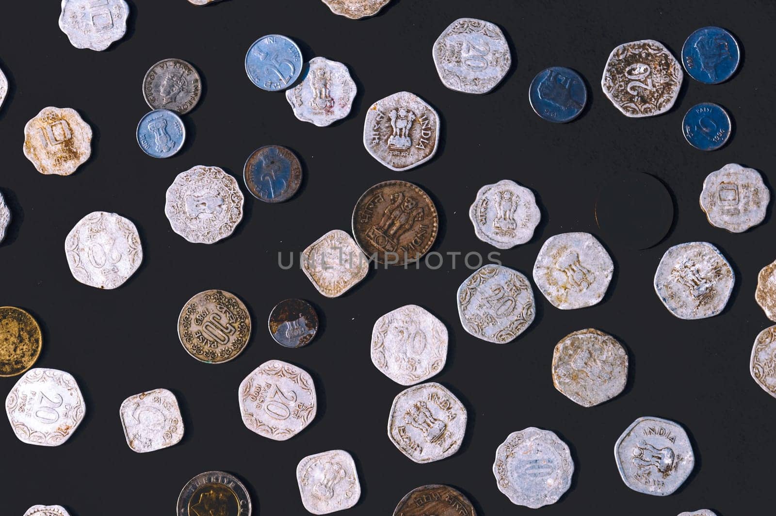 Mix of old antique obsolete Indian Rupee Coin currency on rustic floor. Full Frame. Table Top View. Close Up
