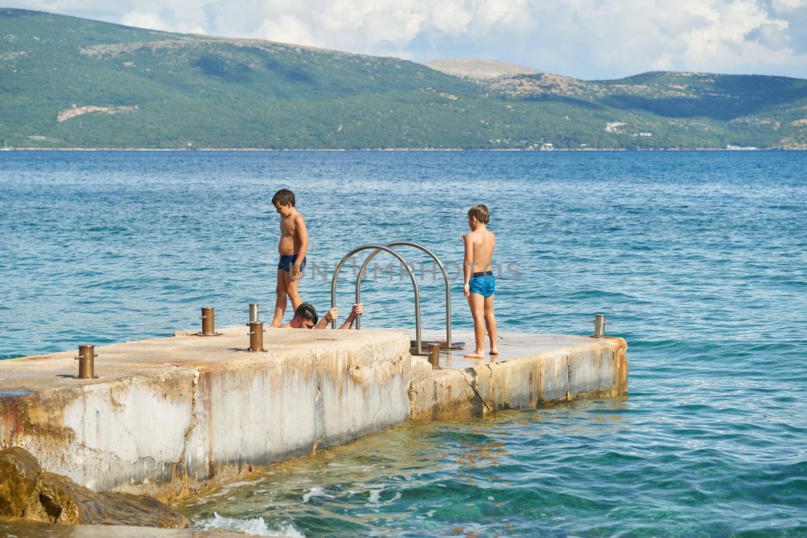Children playing at a bathing place on the Adriatic Sea near the town of Krk in Croatia