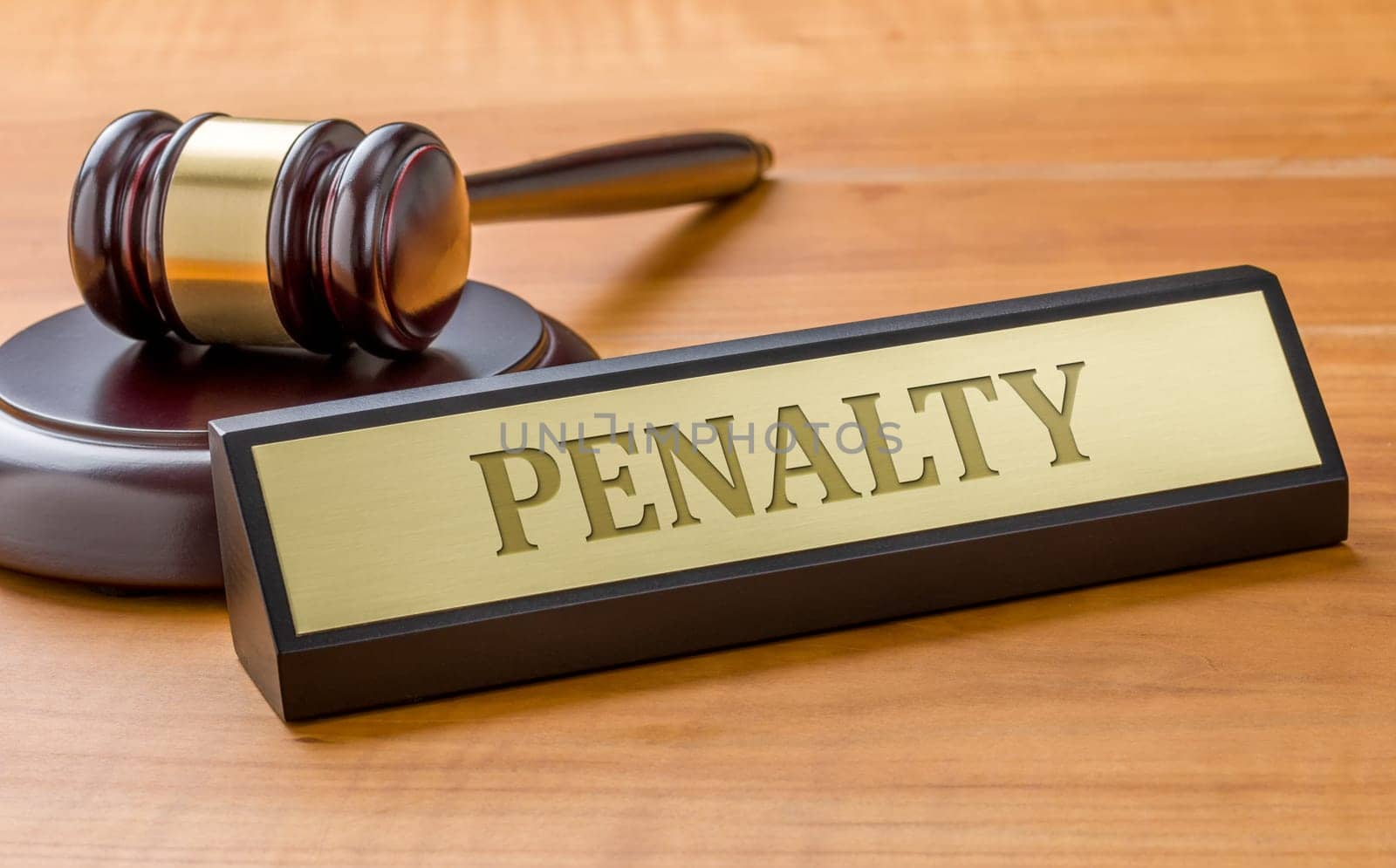 A gavel and a name plate with the engraving Penalty