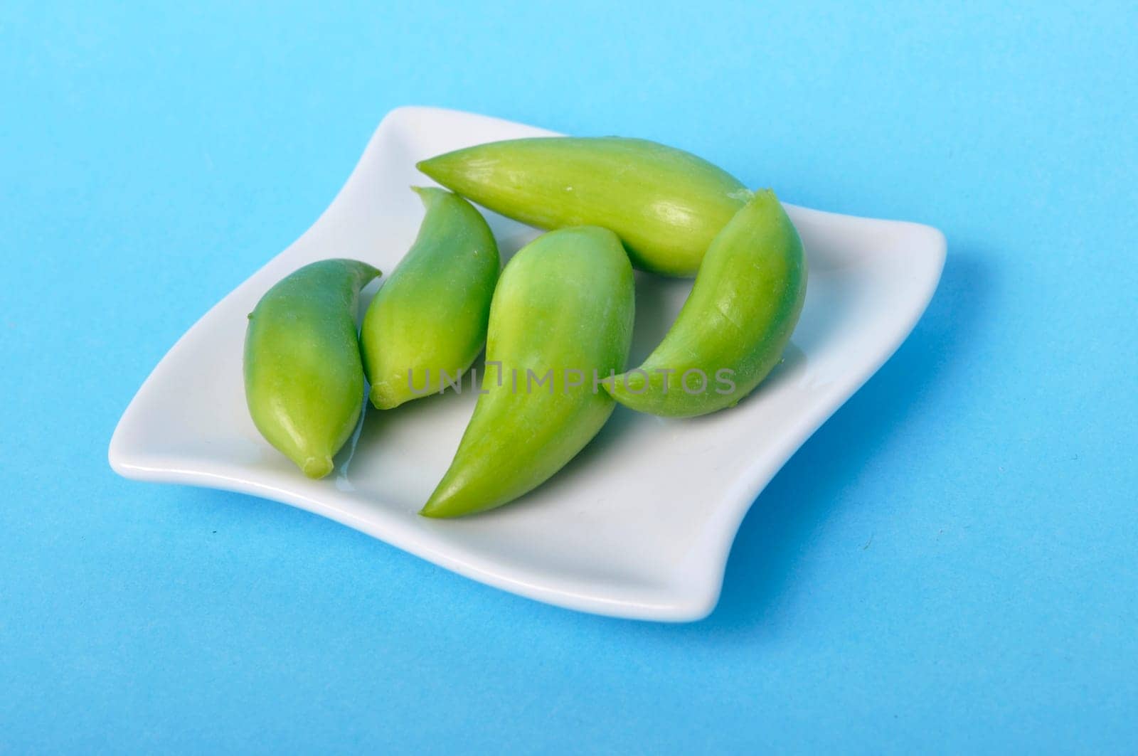 Achocha in a saucer on a blue background