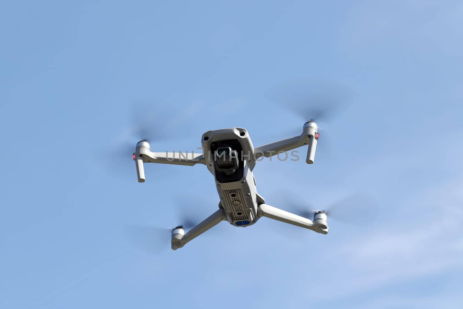 Drone flying in air and clear blue sky background