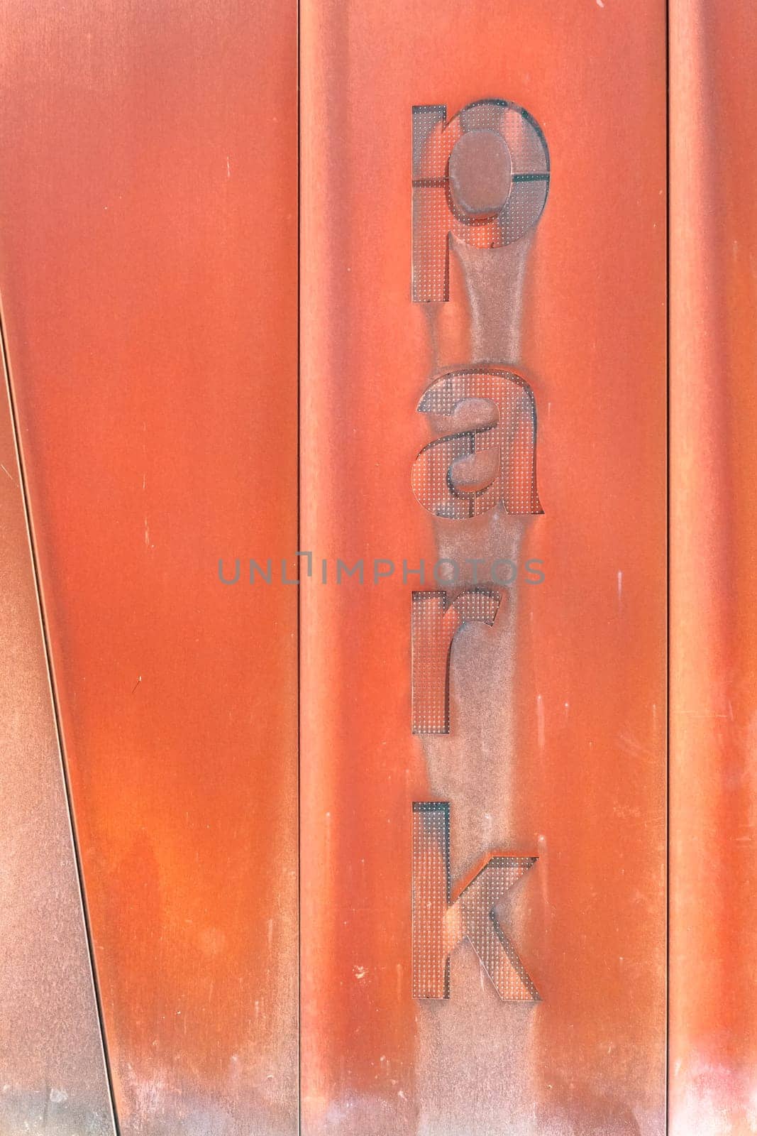 Rusty entrance to a car park. Decorative rust. Modern design. Aged, urban look. City grunge style. Urban architecture.