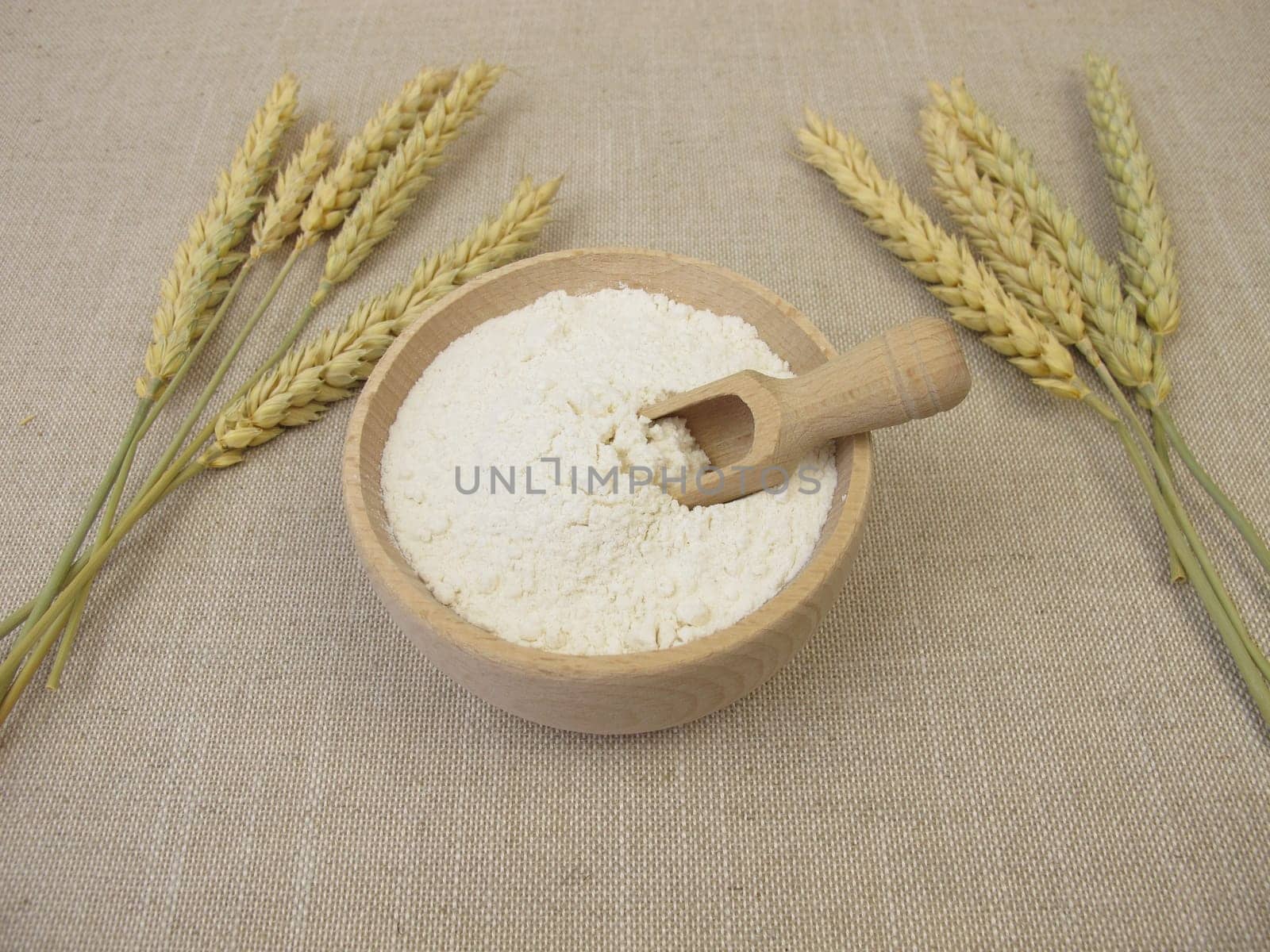 Fine wheat flour in a wooden bowl for the production of baked goods and pasta