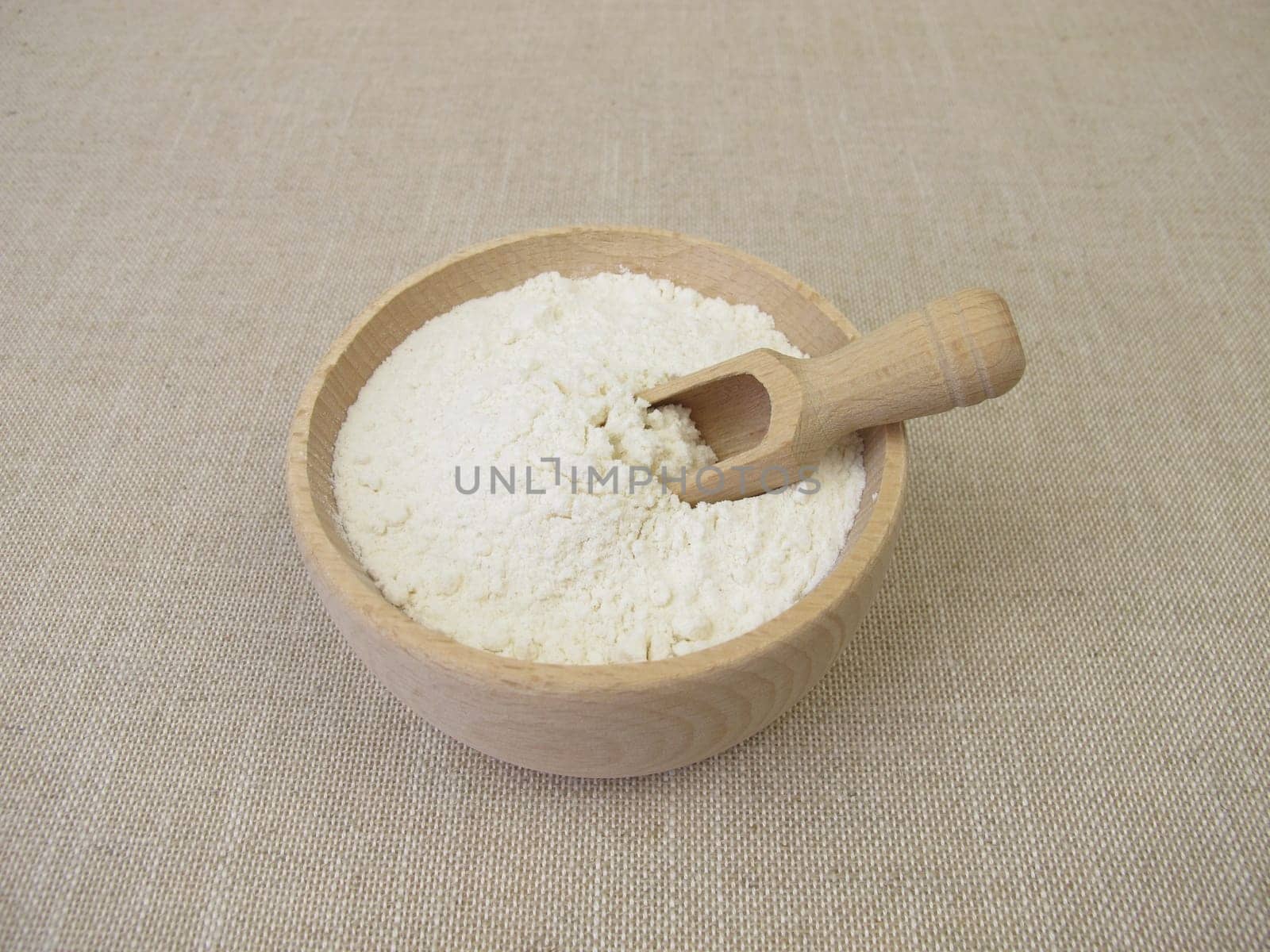 Fine wheat flour in a wooden bowl for the production of baked goods and pasta