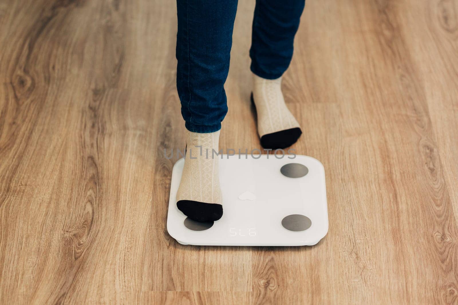 Modern Electronic Device. Girl Measures Weight on Smart Scales.