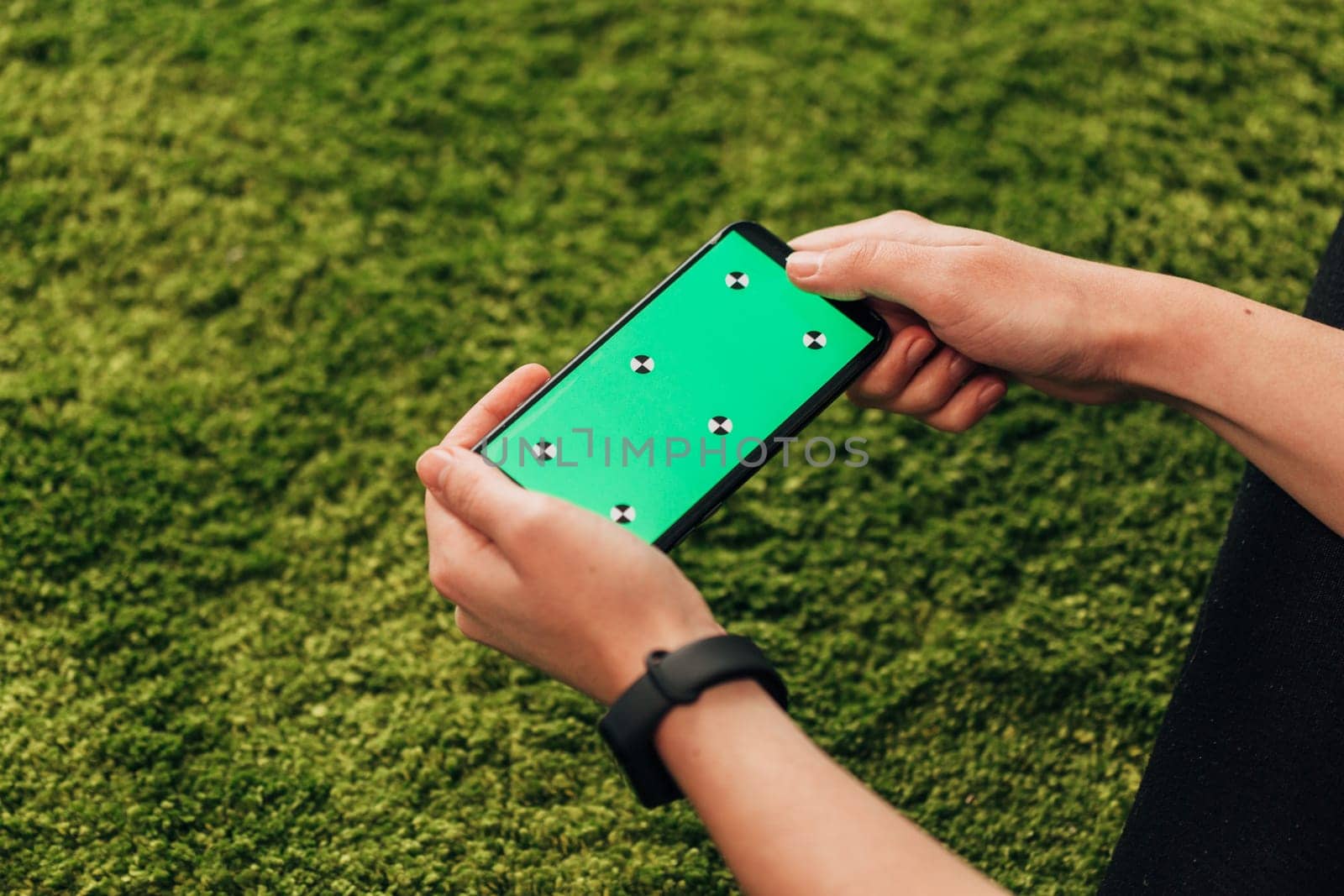 Girl Holds An New Smart Phone In Her Hand. Chroma Key Green.