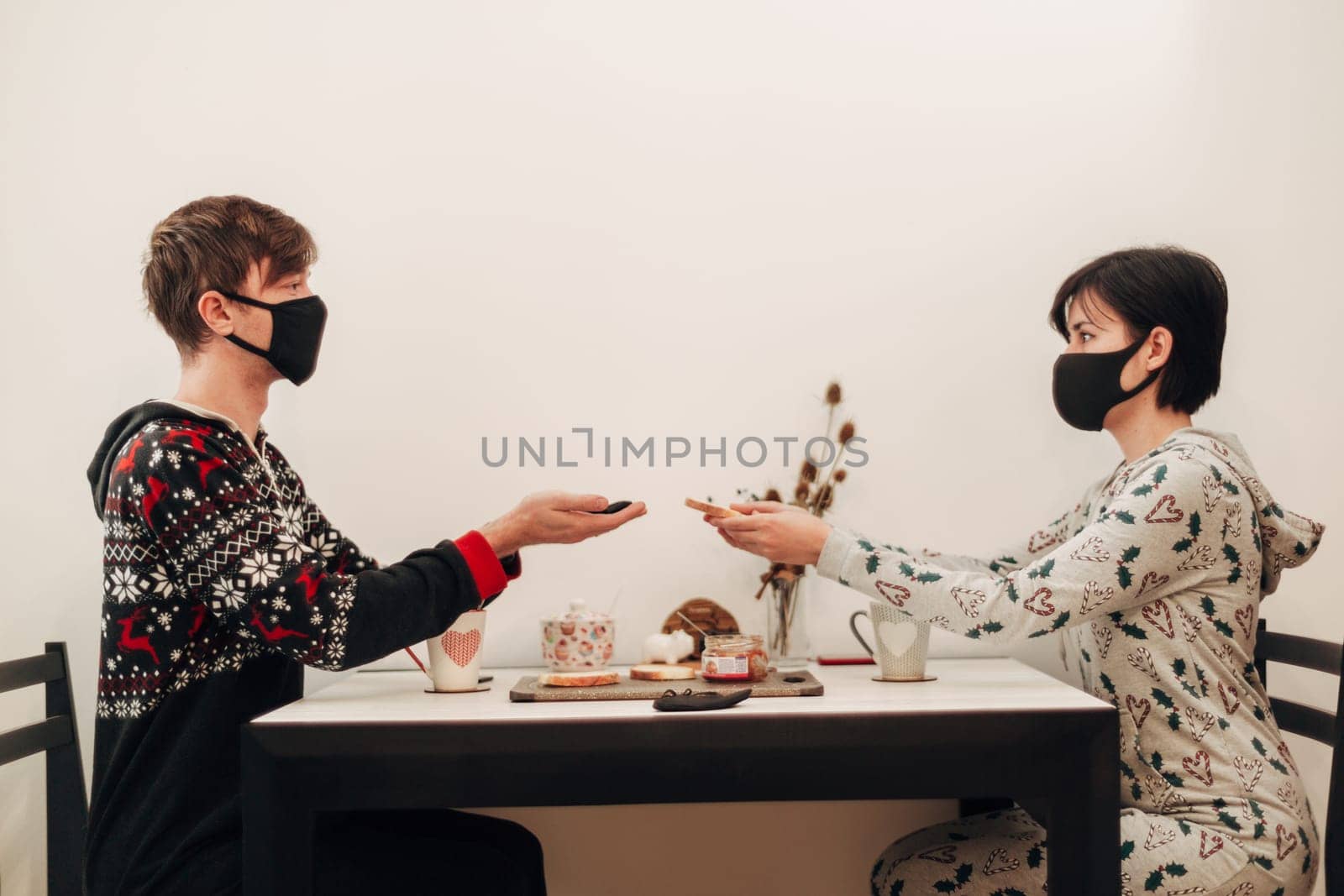 Girl and Guy Drinking Tea at Home in Masks.