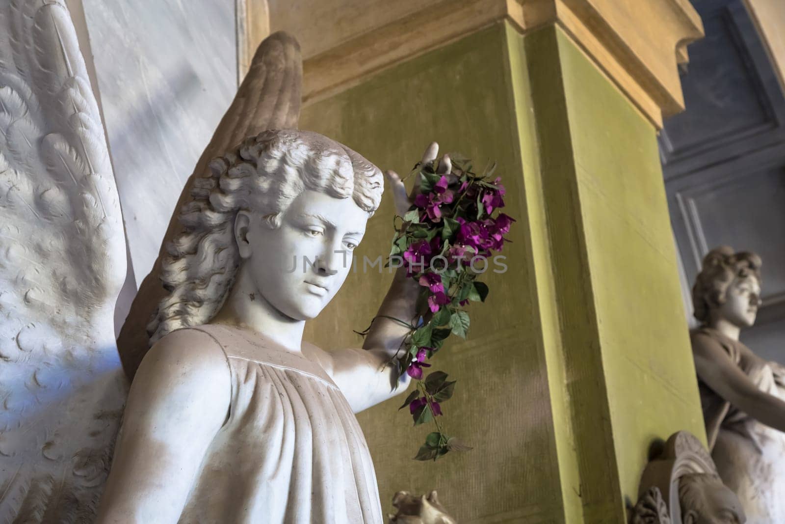 GENOA, ITALY - June 2020: antique statue of angel (beginning 1900, marble) in a Christian Catholic cemetery - Italy