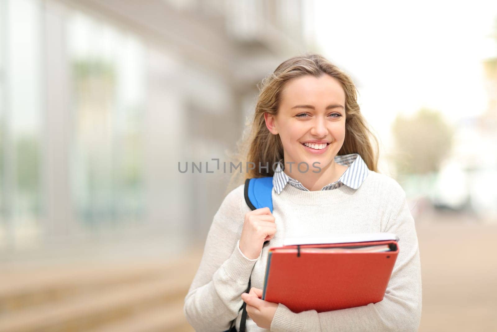 Happy student walking in the street