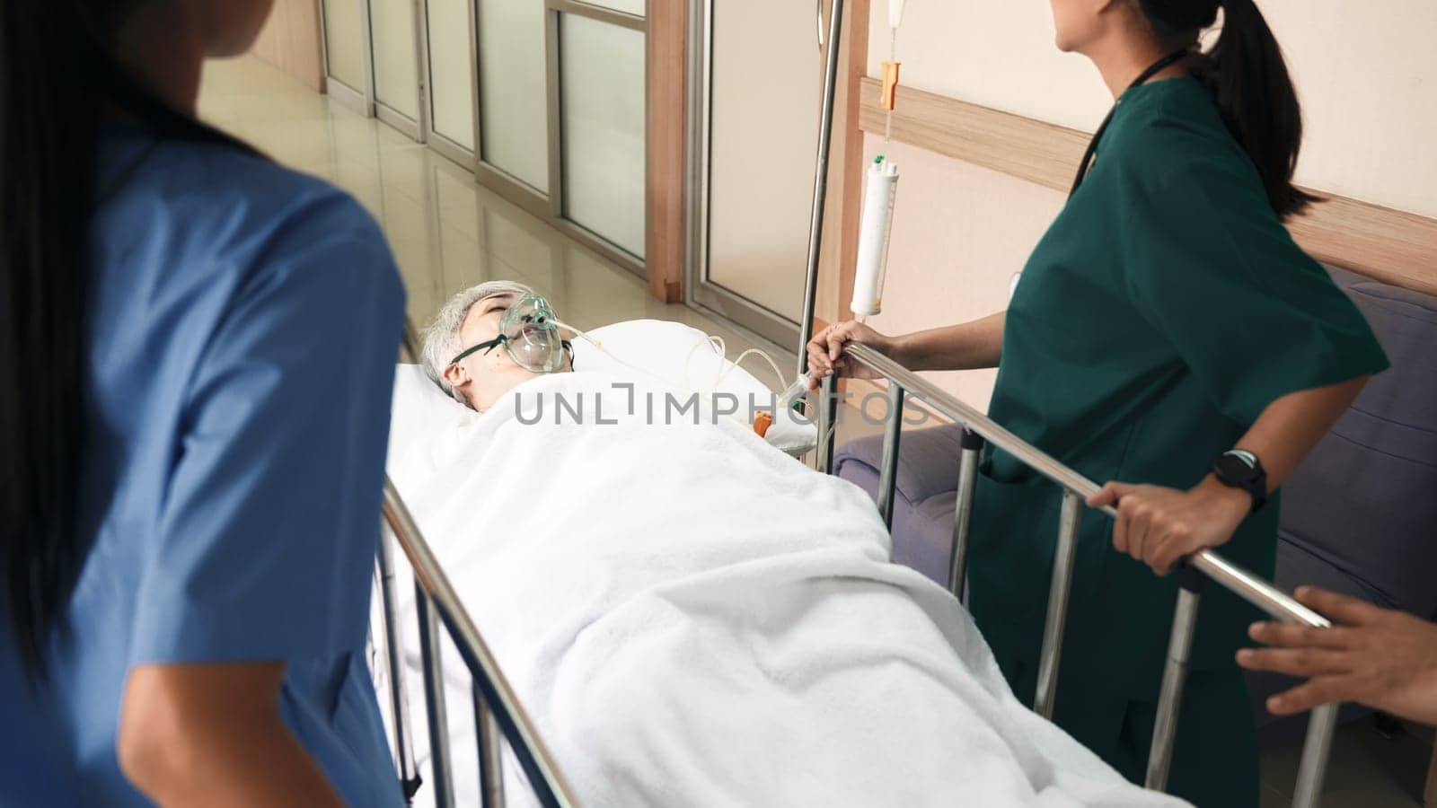 Emergency Department. Nurse and senior doctor team busy push emergency stretcher transport senior patient in hospital, doctors, nurses in surgical gown and white coat uniform running with hurry