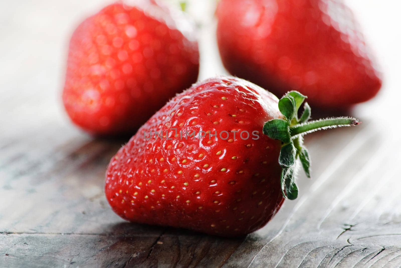 Strawberries on rustick wooden table
