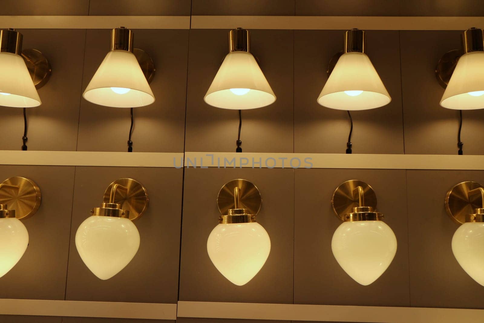 many lamps sconces are hung in a row and lit in the interior