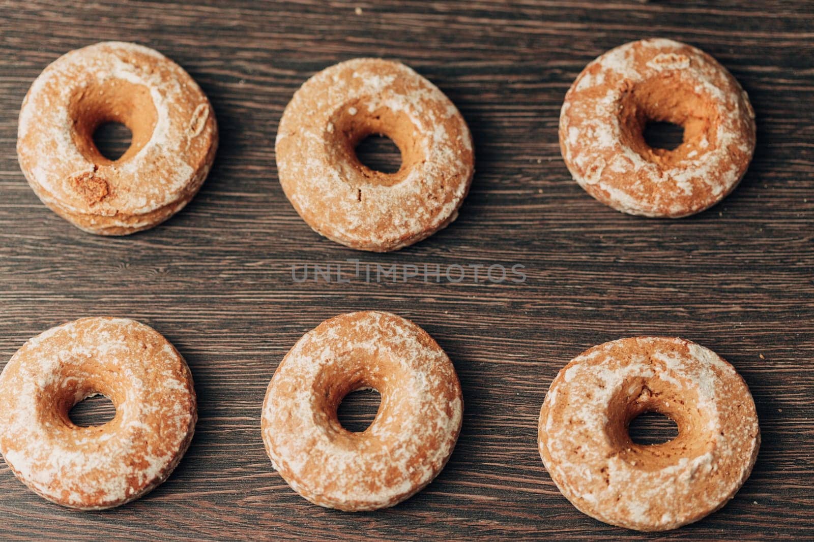 Beautiful Many Bagels and Gingerbreads Lie on a Brown Background