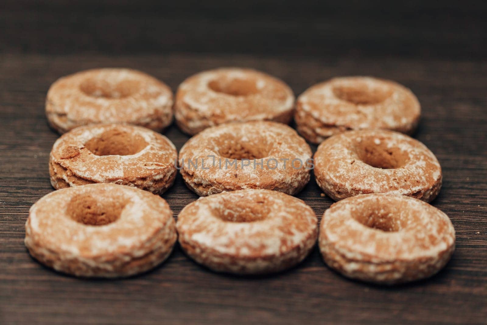 Beautiful Many Bagels and Gingerbreads Lie on a Brown Background