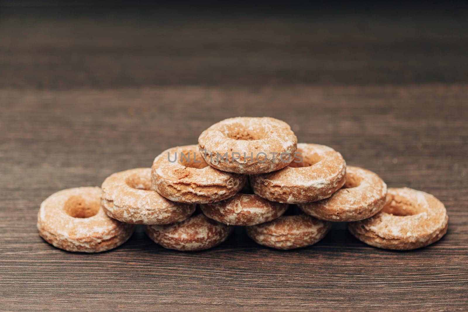 Beautiful Many Bagels and Gingerbreads Lie on a Brown Background