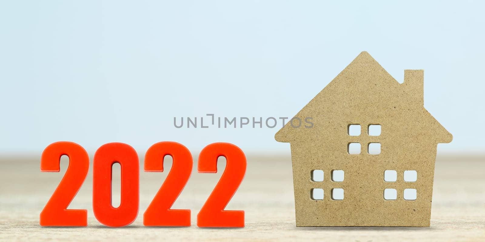 House model and number 2022 on table for finance and banking concept with copy space