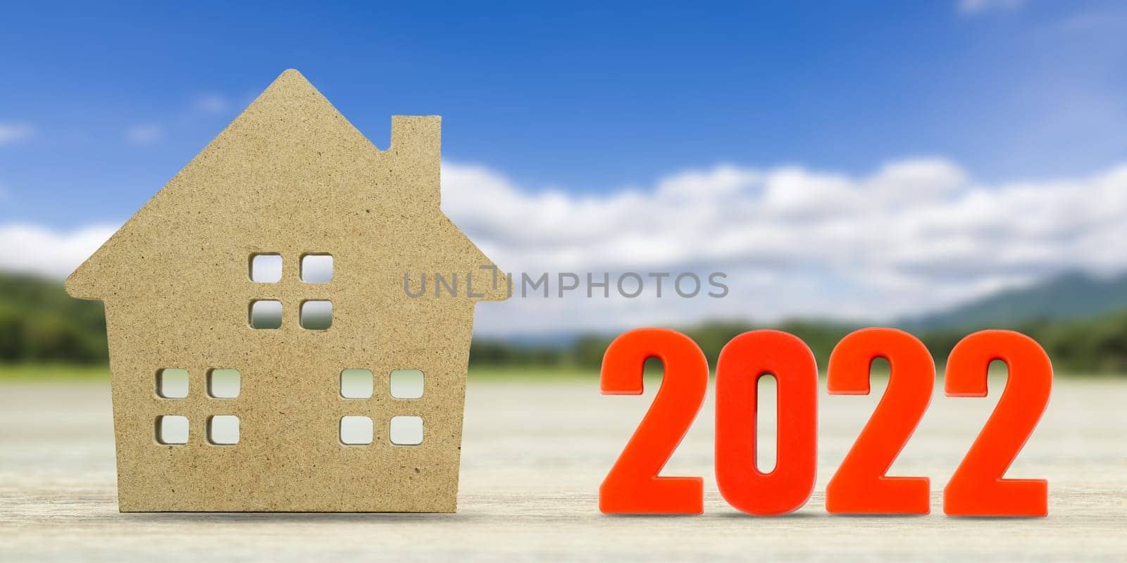 House model and number 2022 with landscape back background for finance and banking concept