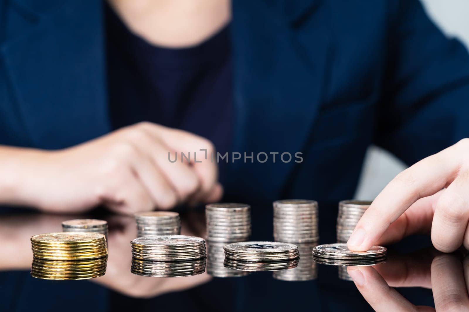 Close up of business woman holding some pieces of golden Bitcoin token , Bitcoin is one of the popular cryptocurrency