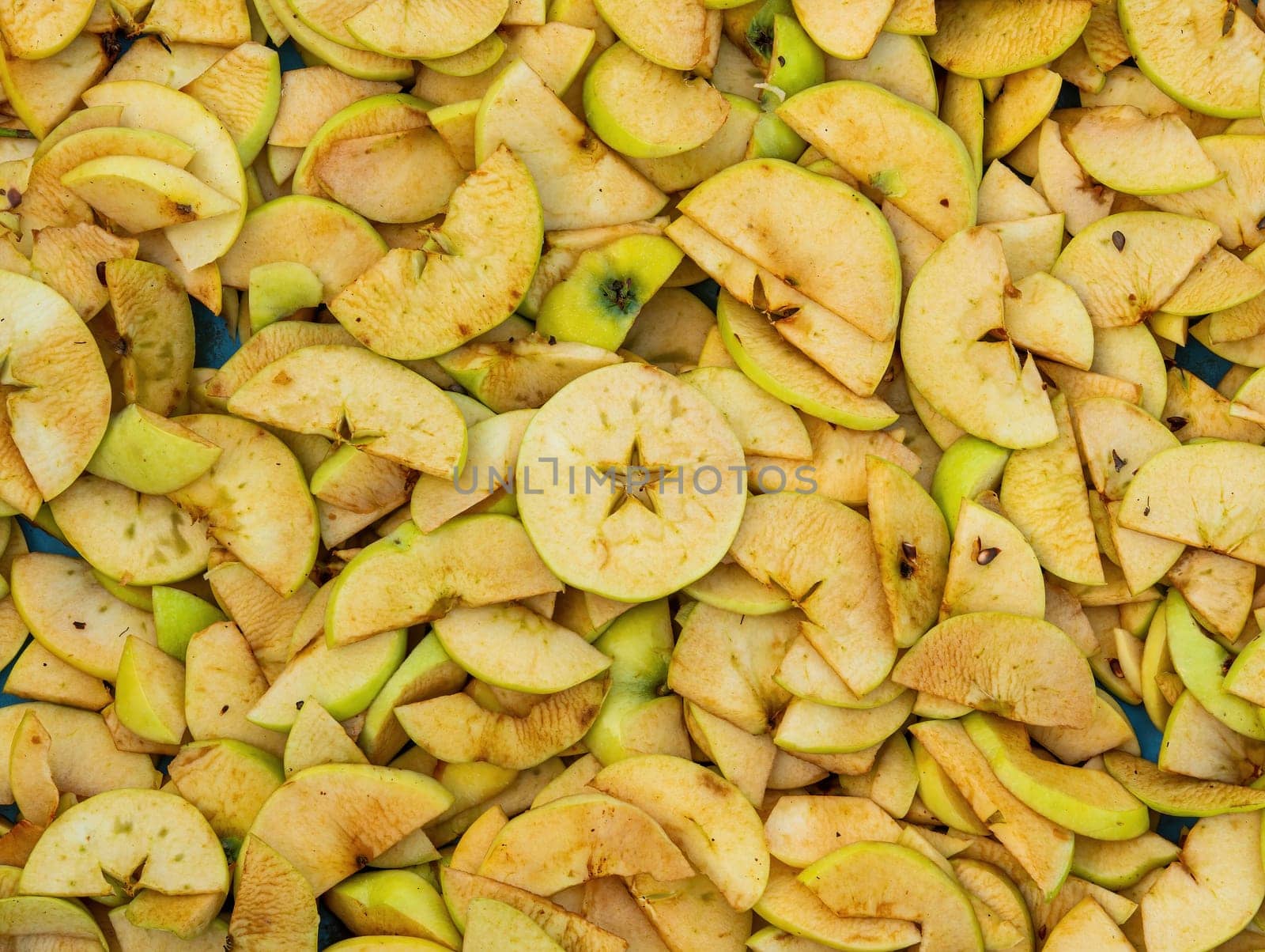 Sliced green fruit apple slices for drying. Fruit drying. Apple juice. Agricultural gardening. Vitamin dessert. Healthy eating. Home kitchen. Cooking food. Grocery product.
