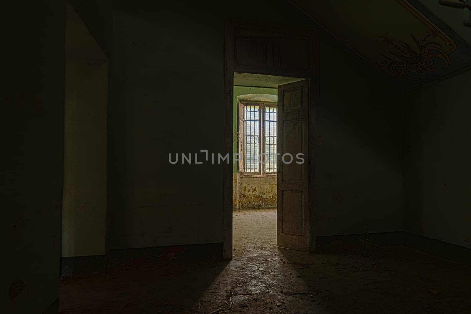 Interior of a decaying abandoned house. Art nouveau colors. Window openings. Mystery and darkness. long exposure times.