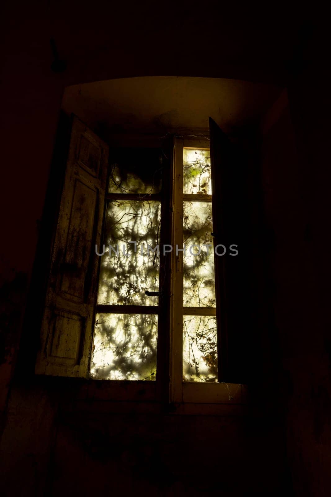 Interior of a decaying abandoned house. Art nouveau colors. Window openings. Mystery and darkness. long exposure times.