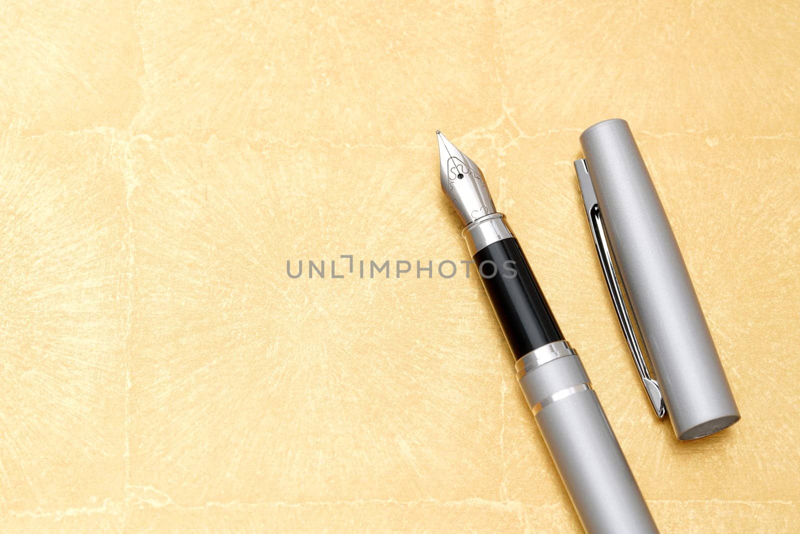 beautiful details of a fountain pen on golden table