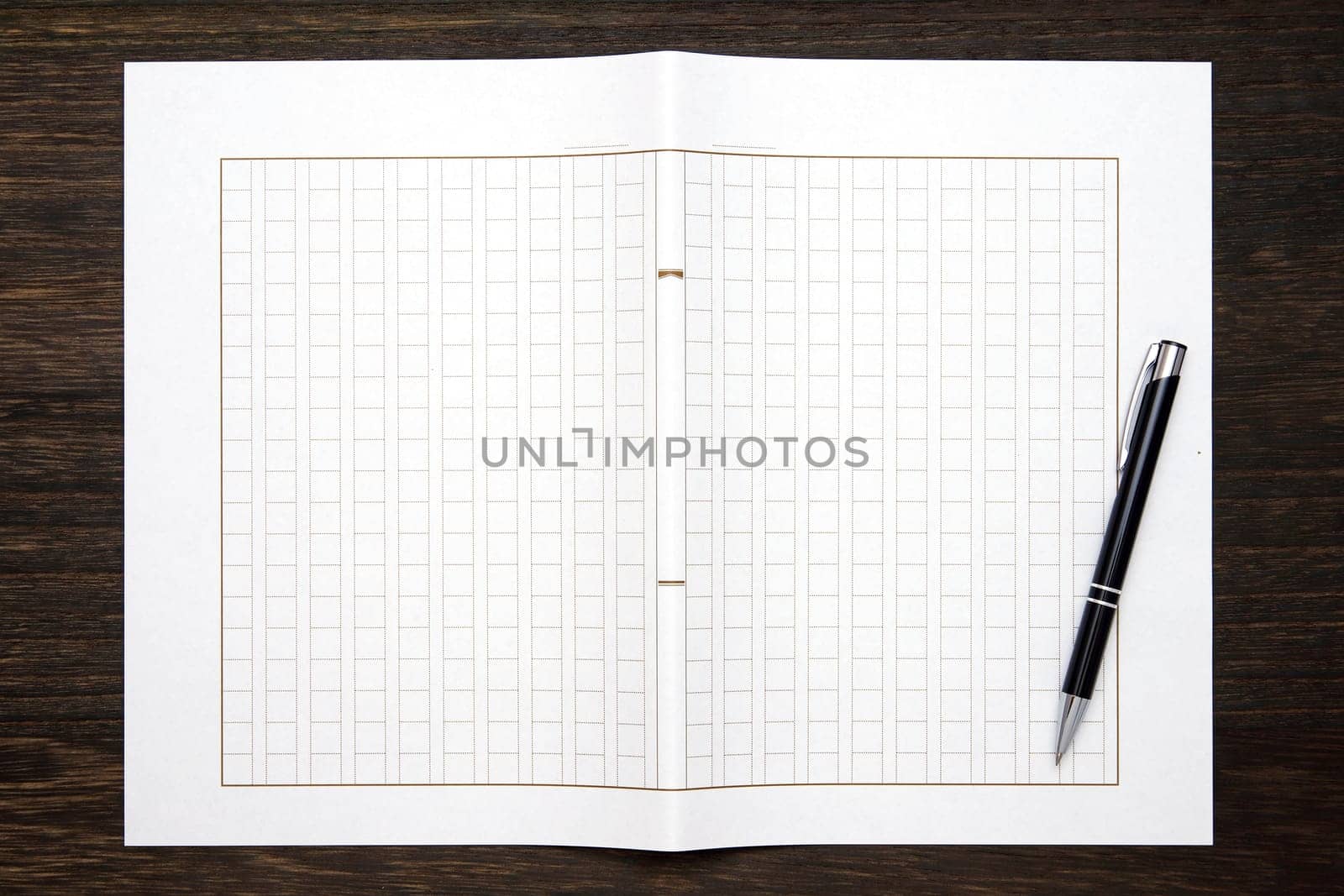 Japanese manuscript paper with ballpoint pen. Genko yoshi on wooden table