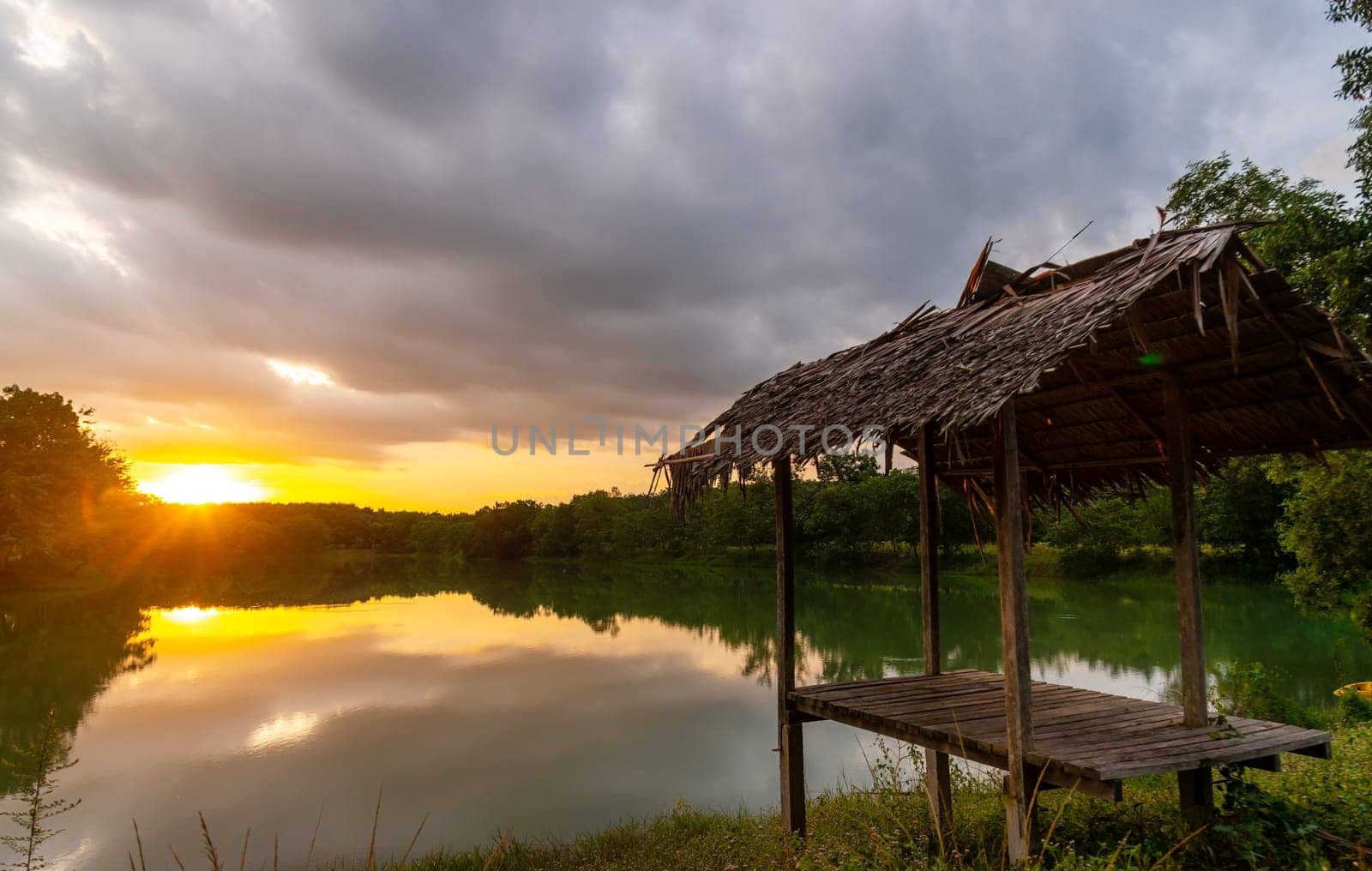 View of Colorful dramatic sky sunset or sunrise with clouds background on Water River in Forest, Sky with cloud in nature and travel concept.