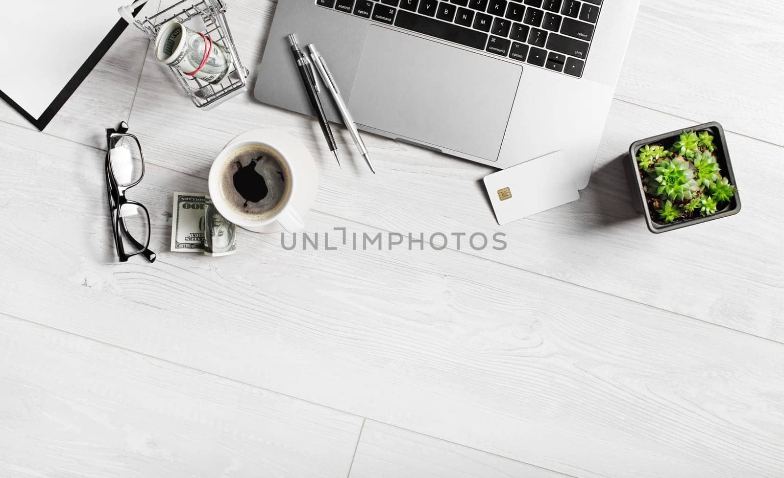 Stationery and gadgets on wooden background. Copy space. Flat lay.