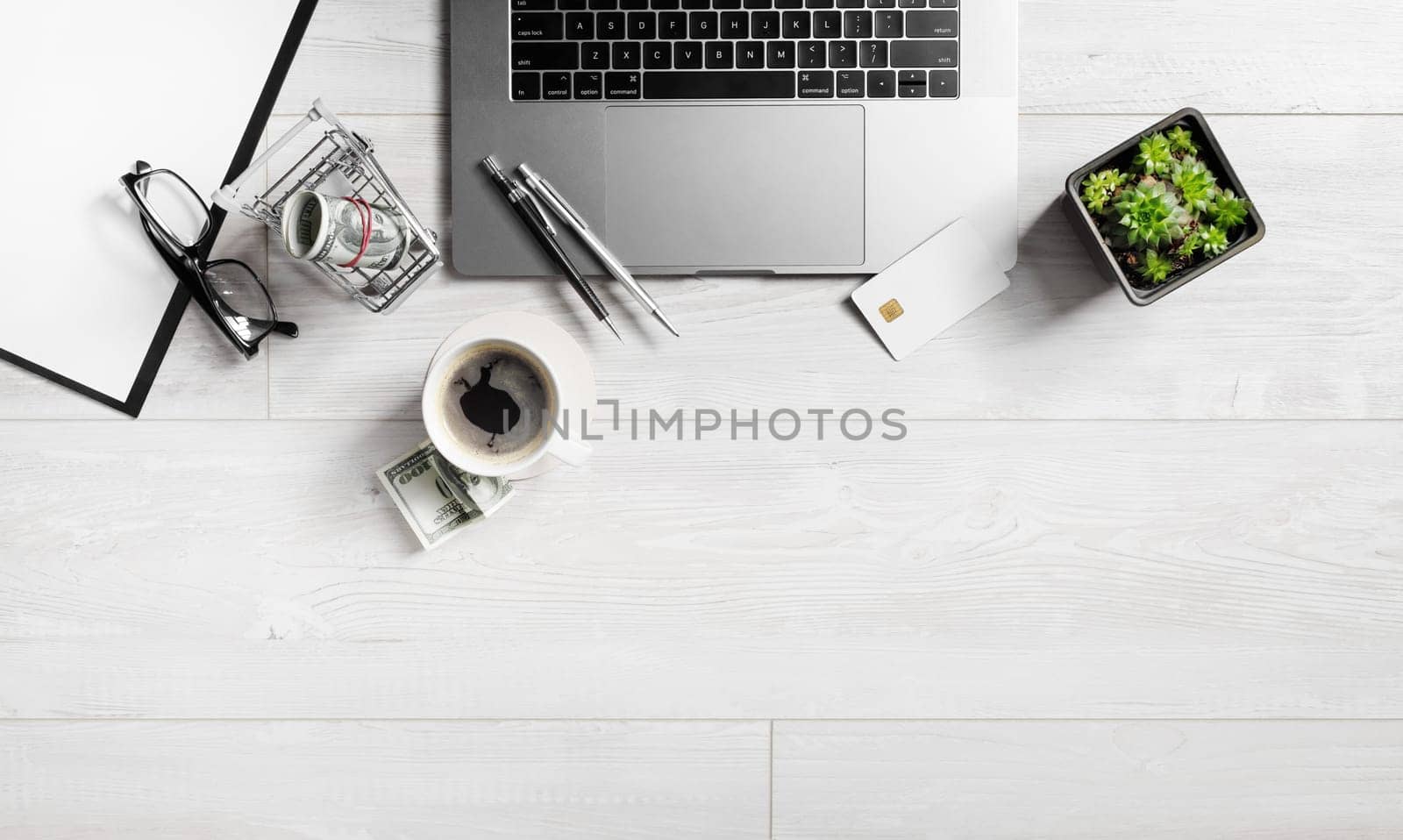 Office supplies and gadgets on wooden background. Copy space. Flat lay.
