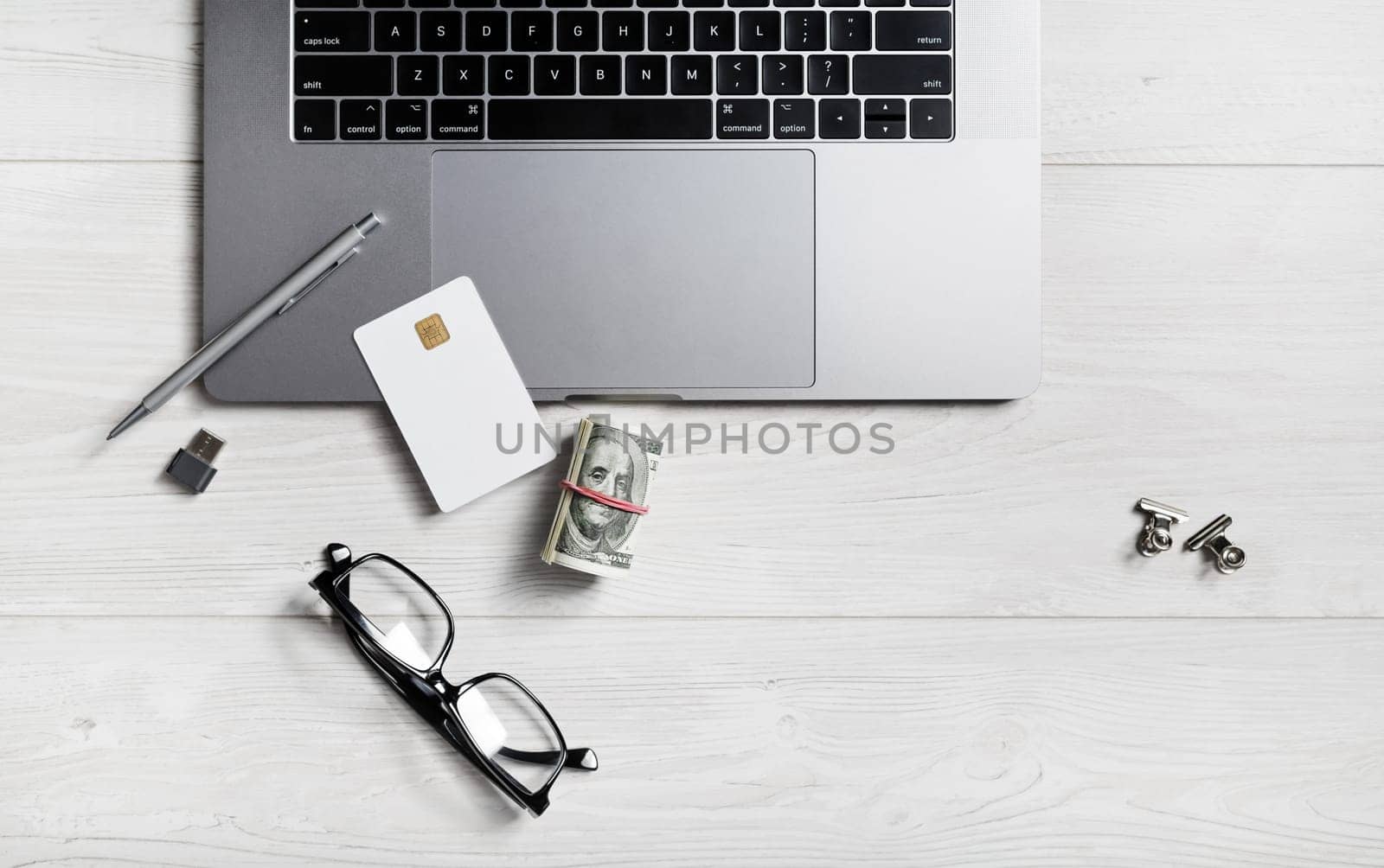 Laptop and office supplies on wooden background. Online shopping concept.