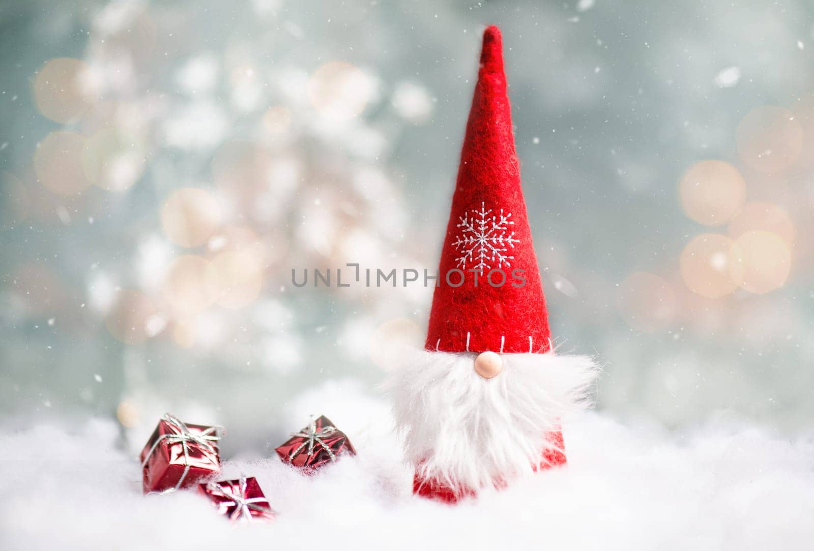 Christmas gnome greeting card with bokeh lights and snow, winter season, gift on the sledge