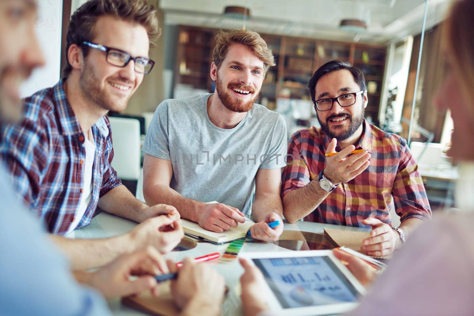 Group of male employees talking to co-worker