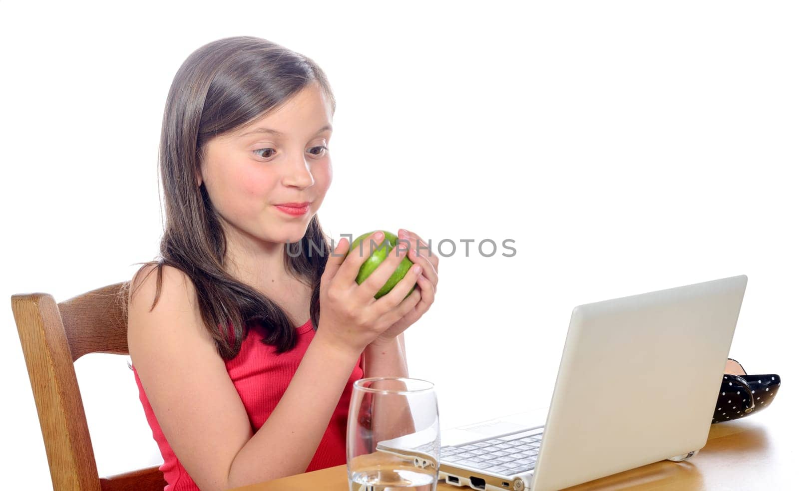 a little girl at her desk with an apple