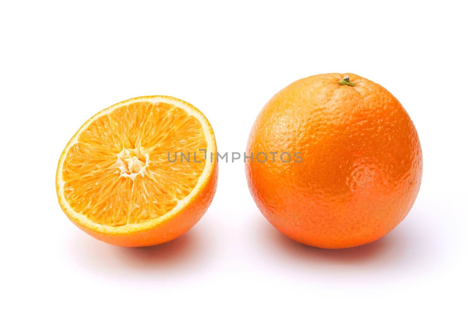 Oranges on white background. One whole and a half.