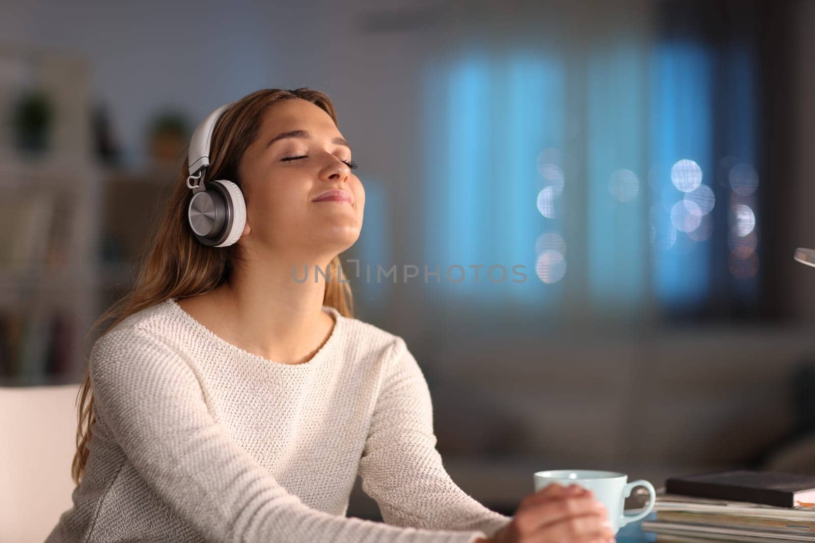 Female listening to music wearing headphones