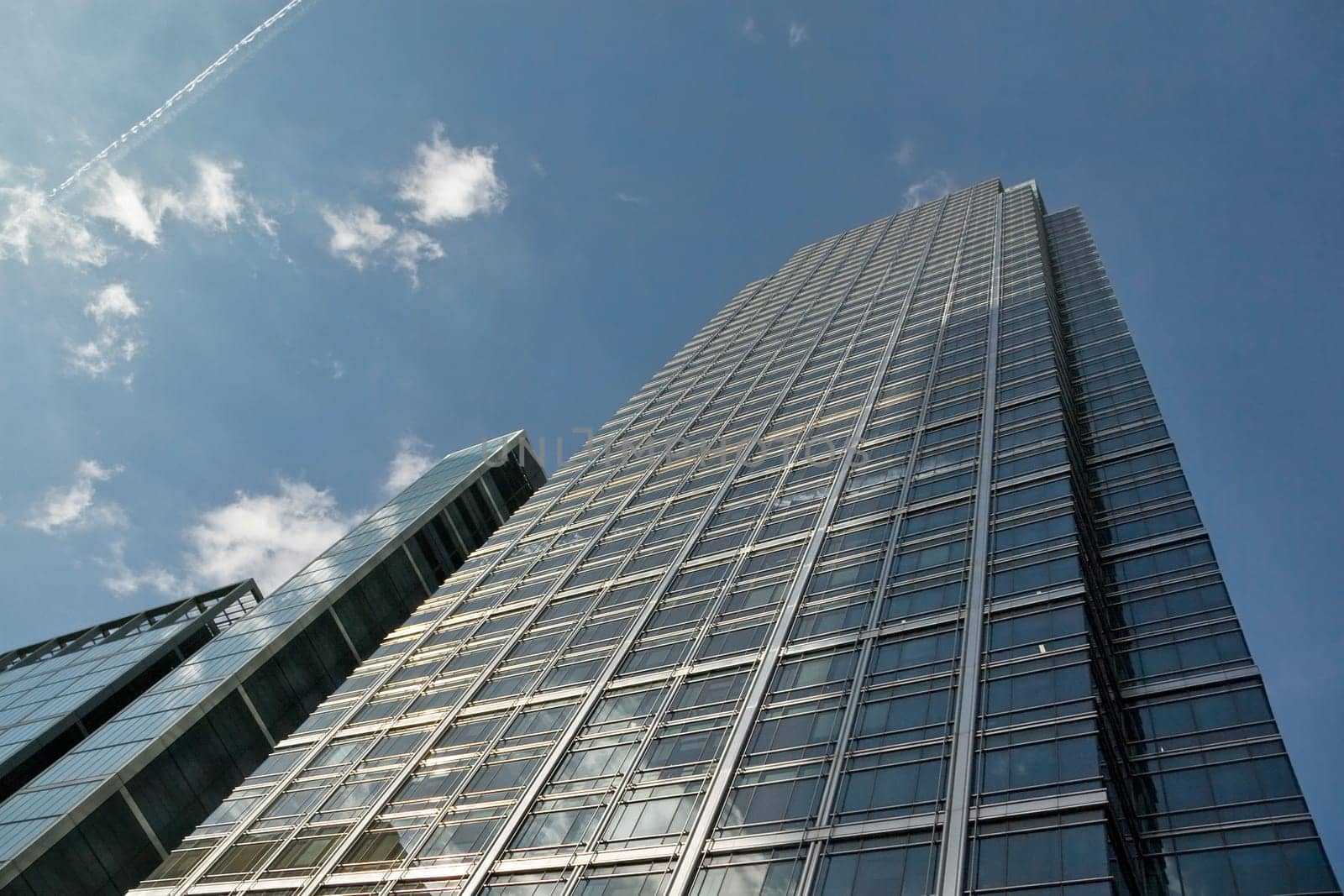 London, United Kingdom - October 10, 2006: Glass and steel offices ("More London Estates"" designed by Foster and Partners) sky and clouds in background. Example of modern architecture in UK capital"