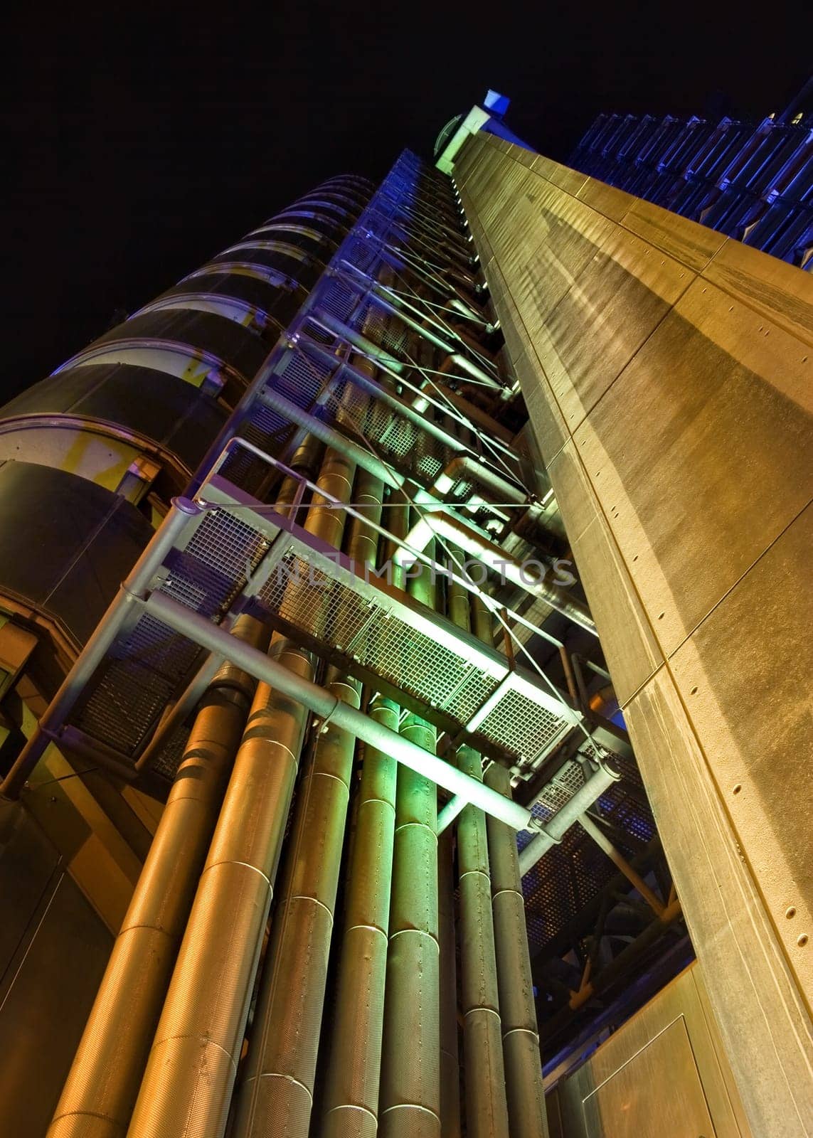 London, United Kingdom - October 7th, 2006: Lloyd's building (the Inside-Out Building) illuminated with yellow and blue light. Example of modern architecture in UK capital, designed by Richard Rogers