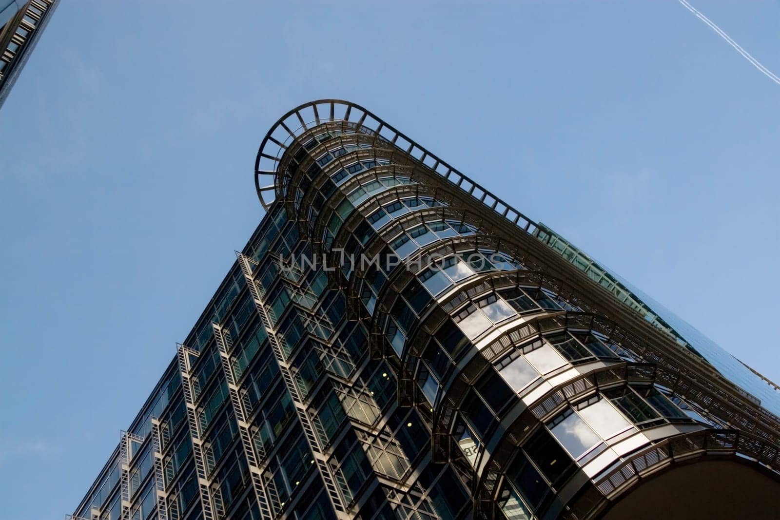 London, United Kingdom - October 10, 2006: Glass and steel offices ("4 More London Riverside"" designed by Foster and Partners), view to top, with clear sky above. Example of modern architecture in UK"