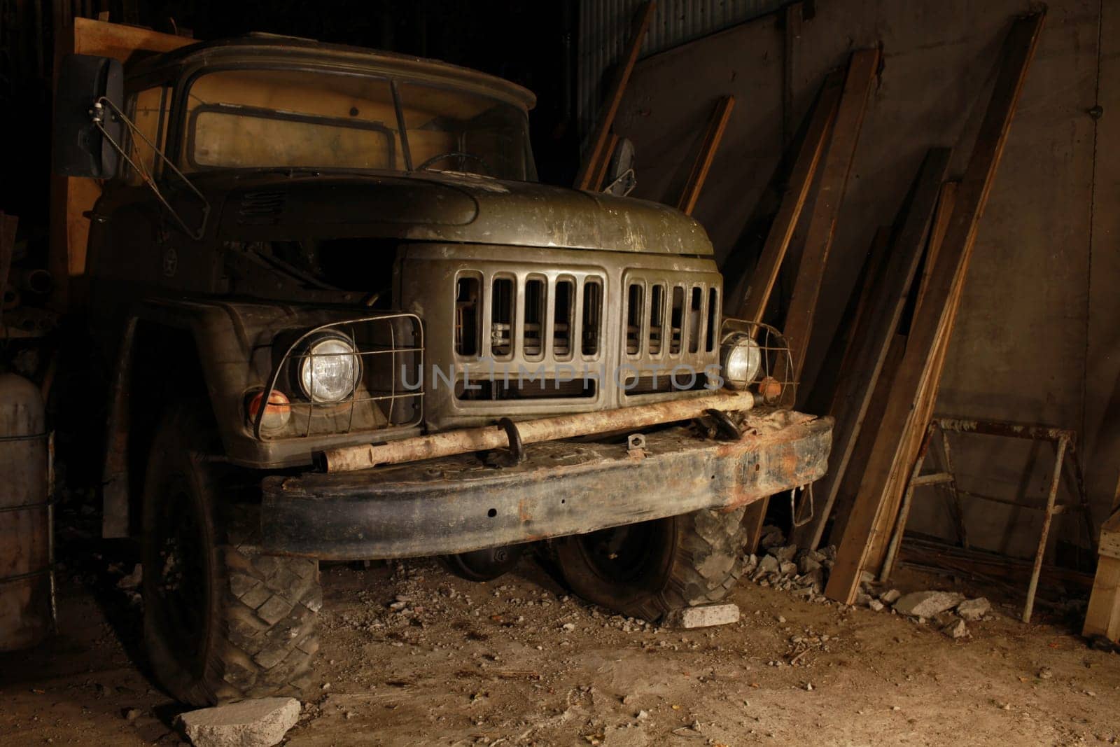 old army truck in a dark garage front view