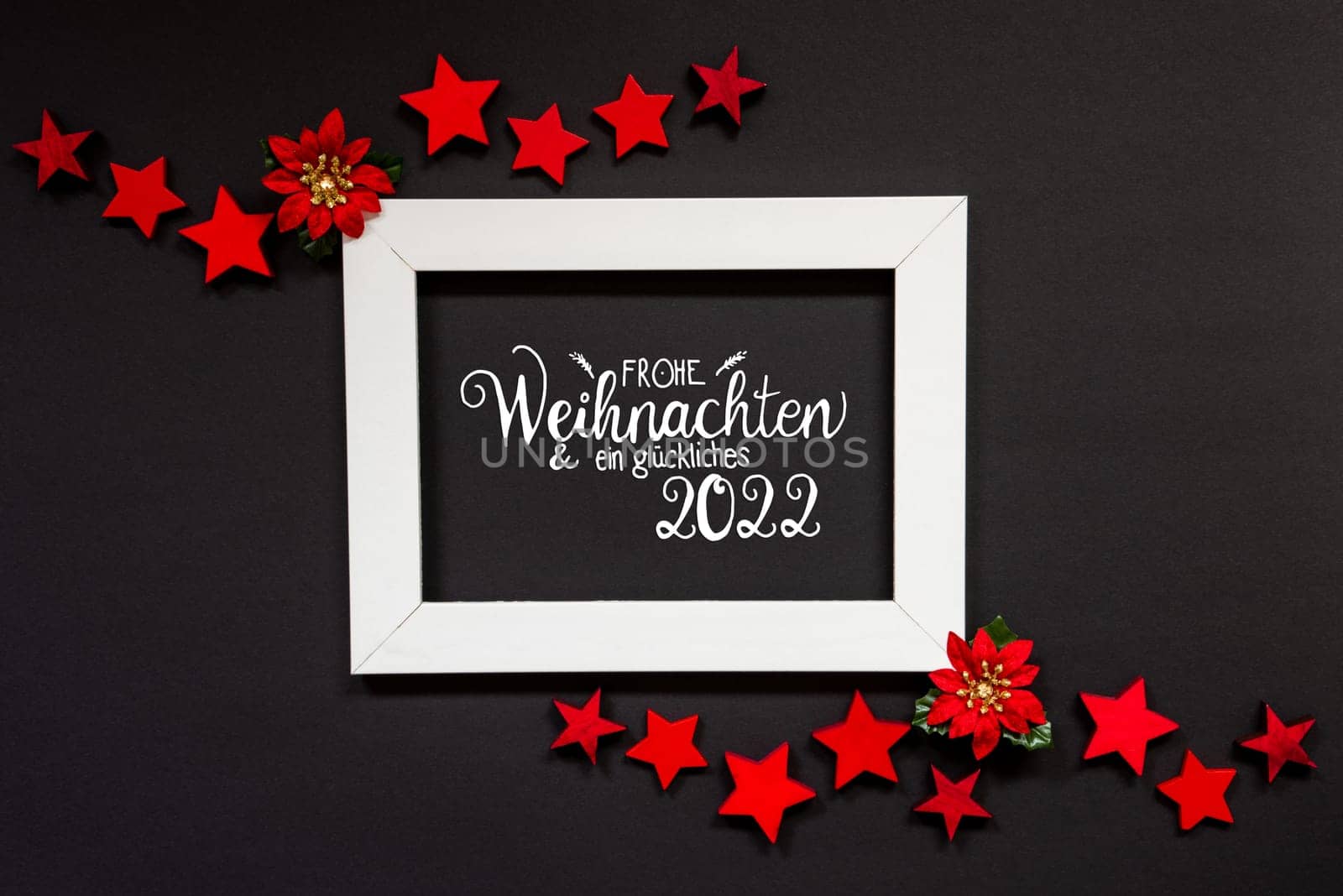 Frame With German Text Frohe Weihnachten Und Ein Glueckliches 2022 Means Merry Christmas And A Happy 2022. Christmas Decoration And Ornament Like Red Winter Rose And Stars. Black Background
