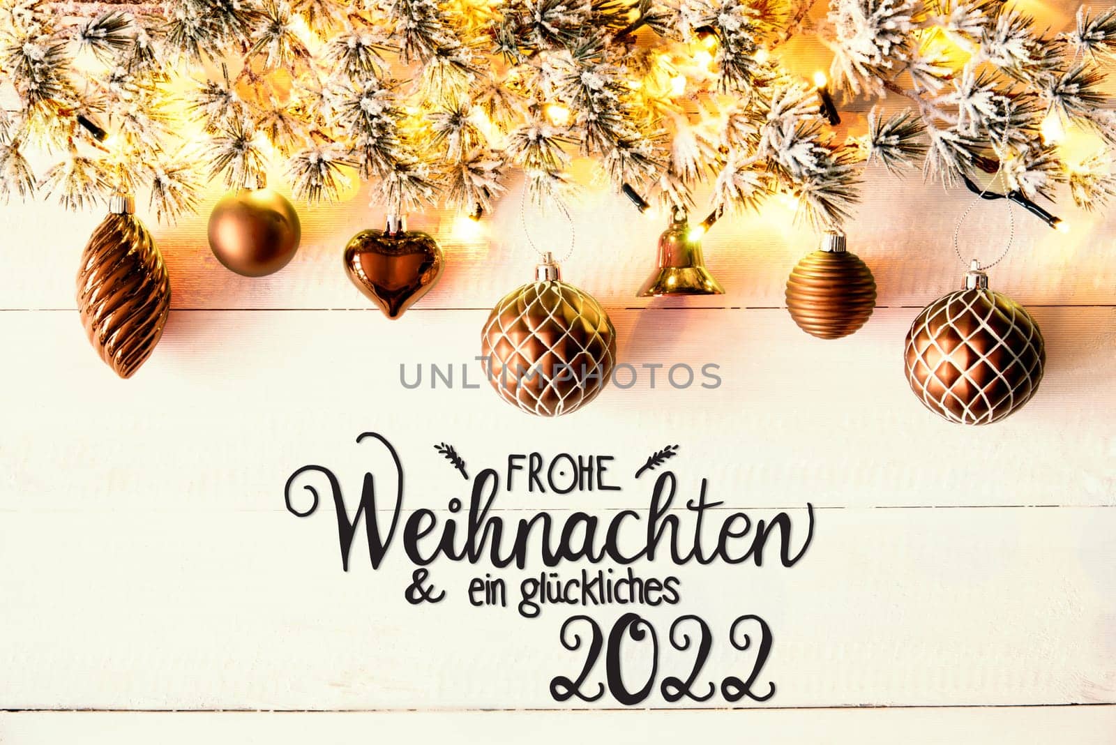 Golden Christmas Decoration With German Calligraphy Frohe Weihnachten Und Ein Glueckliches 2022 Mean Merry Christmas And A Happy 2022. Fir Tree Branch With Shiny Fairy Lights