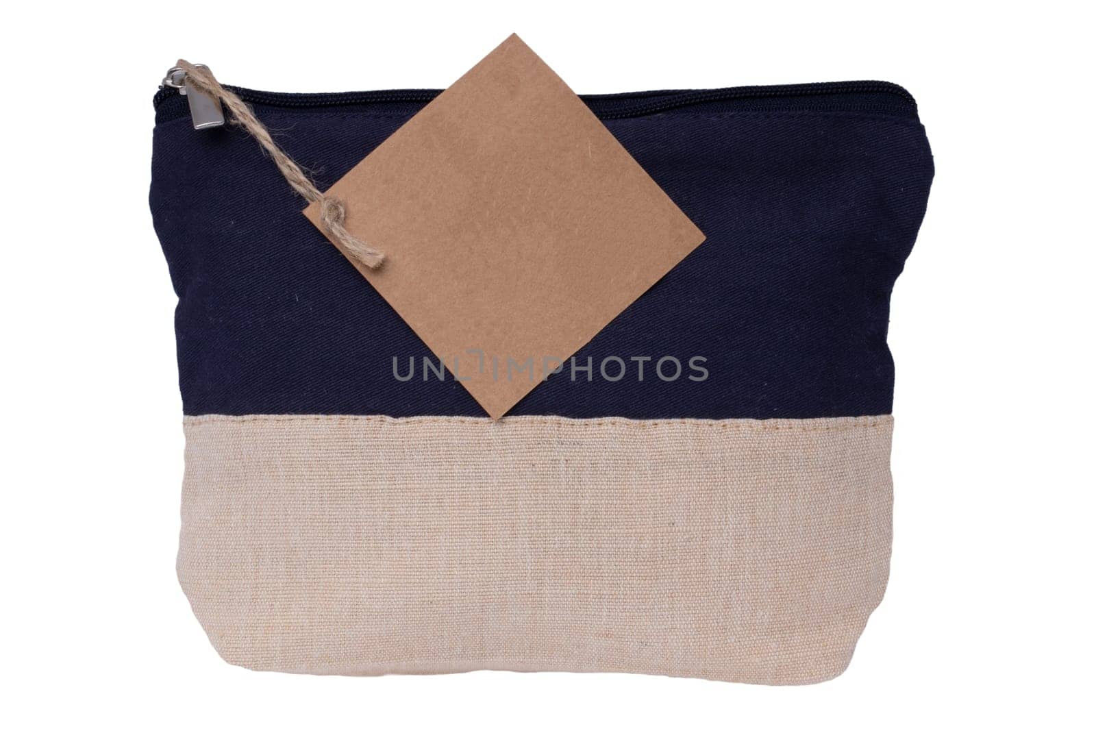 Cosmetic bags single. Close-up of a beautiful black and beige cosmetic bag with a brown tag isolated on a white background. Macro. Used for essential equipment brushes for make-up and cosmetic products.
