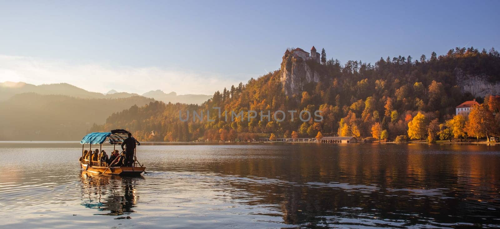Traditional wooden boat on picture perfect picturesque lake Bled, Slovenia at sunset.