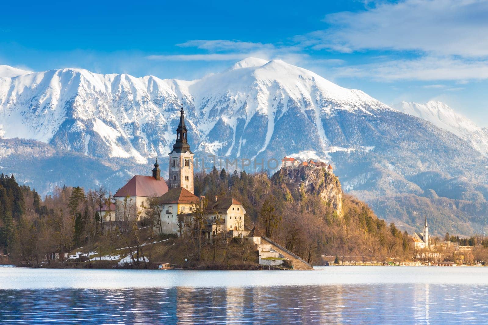 Panoramic view of Julian Alps, Lake Bled with St. Marys Church of the Assumption on the small island. Bled, Slovenia, Europe.